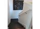 Clean stairwell with dark wood stairs and white walls displaying modern art at 4832 Batiste Ln, Acworth, GA 30101