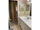 Bathroom featuring a vanity with white cabinets, a large mirror, and a view to other rooms at 8660 Bowden St, Douglasville, GA 30134