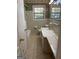 Classic bathroom with a tub, white tile, and a vanity with a marble-look countertop at 8660 Bowden St, Douglasville, GA 30134