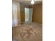 Bedroom featuring neutral carpet, ample closet space, and access to additional rooms at 8660 Bowden St, Douglasville, GA 30134
