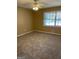 Cozy bedroom with ceiling fan, neutral carpeting, and a large window offering natural light at 8660 Bowden St, Douglasville, GA 30134