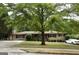 Charming brick ranch home featuring a large tree and well-manicured lawn at 8660 Bowden St, Douglasville, GA 30134