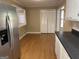 Bright kitchen featuring white cabinets, black countertops, and stainless steel refrigerator at 8660 Bowden St, Douglasville, GA 30134