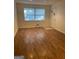 Bright living room features updated flooring and a large window for natural light at 8660 Bowden St, Douglasville, GA 30134