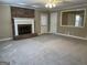 Living room featuring neutral paint, carpet, fireplace and a doorway to another area at 8660 Bowden St, Douglasville, GA 30134