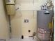Image shows a utility room with a water heater and a central vacuum system for the home at 8660 Bowden St, Douglasville, GA 30134