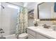 Bright bathroom with subway tile, floral shower curtain, and a decorative mirror at 8710 Gilmer Ft, Cumming, GA 30028
