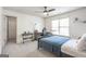 Comfortable bedroom featuring carpeted floors, a ceiling fan, and ample natural light at 8710 Gilmer Ft, Cumming, GA 30028