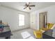 Bright bedroom with ample sunlight, neutral walls, and a sitting area at 8710 Gilmer Ft, Cumming, GA 30028