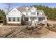 Charming two-story home with inviting front porch and mature landscaping in winter at 8710 Gilmer Ft, Cumming, GA 30028