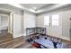Basement gym with a work area has hardwood floors, recessed lights, and double doors at 8710 Gilmer Ft, Cumming, GA 30028
