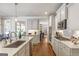 Bright kitchen with stainless appliances, white cabinets, and an eat-in dining area at 8710 Gilmer Ft, Cumming, GA 30028