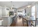 Modern kitchen with white cabinets, quartz countertops, stainless steel appliances, and bar seating at 8710 Gilmer Ft, Cumming, GA 30028