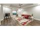 Finished basement living area with hardwood floors, recessed lighting, and a red leather couch at 8710 Gilmer Ft, Cumming, GA 30028