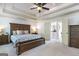 Spacious main bedroom features a tray ceiling and a sitting area with an ensuite bathroom at 8710 Gilmer Ft, Cumming, GA 30028