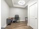 Basement office features neutral paint, hardwood floors, and a desk with black office chair at 8710 Gilmer Ft, Cumming, GA 30028