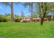 Spacious front yard with mature trees surrounding a two-story home with manicured lawn at 543 Tahoe Cir, Stone Mountain, GA 30083