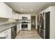 Updated kitchen with stainless appliances, granite countertops, and modern white cabinets at 543 Tahoe Cir, Stone Mountain, GA 30083