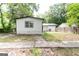 Backyard exterior of home with a new window, grass and sidewalk to a shed at 6532 Voyles Dr, Riverdale, GA 30274