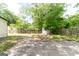 View of fenced backyard with shed, grass and concrete patio at 6532 Voyles Dr, Riverdale, GA 30274