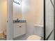 Half bathroom with a white single sink vanity and toilet with granite countertop at 6532 Voyles Dr, Riverdale, GA 30274