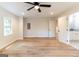 Large bedroom with wood floors and adjacent view to kitchen and bathroom at 6532 Voyles Dr, Riverdale, GA 30274