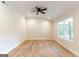 Bright bedroom featuring sleek, modern flooring, neutral paint, and ample natural light at 6532 Voyles Dr, Riverdale, GA 30274