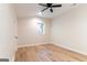 A bright, empty bedroom with a ceiling fan and light wood-look flooring at 6532 Voyles Dr, Riverdale, GA 30274