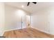 A bright, empty bedroom with a ceiling fan and light wood-look flooring at 6532 Voyles Dr, Riverdale, GA 30274