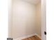 A simple, unfinished walk-in closet with light wood-look flooring at 6532 Voyles Dr, Riverdale, GA 30274