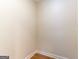 A simple, unfinished walk-in closet with light wood-look flooring at 6532 Voyles Dr, Riverdale, GA 30274