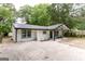 Lovely home with a well-maintained lawn and a charming covered porch at 6532 Voyles Dr, Riverdale, GA 30274