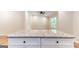 Kitchen island features white cabinets and granite countertop at 6532 Voyles Dr, Riverdale, GA 30274