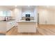 Modern kitchen with white cabinets, granite countertops, and a central island at 6532 Voyles Dr, Riverdale, GA 30274