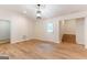 Bright living room with wood floors and modern light fixture at 6532 Voyles Dr, Riverdale, GA 30274