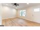 Bright living room with wood floors, ceiling fan, and a window for natural light at 6532 Voyles Dr, Riverdale, GA 30274