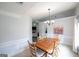 Elegant dining room with natural light and a traditional chandelier at 95 Blue Grass Ct, Oxford, GA 30054
