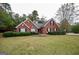 Traditional red brick home with lush green lawn and neatly trimmed hedges at 95 Blue Grass Ct, Oxford, GA 30054