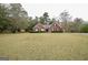 Traditional brick home with a well-maintained lawn and symmetrical landscaping at 95 Blue Grass Ct, Oxford, GA 30054