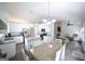 Spacious eat-in kitchen features stainless appliances, white cabinetry, an island, and hardwood floors at 95 Blue Grass Ct, Oxford, GA 30054