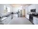 Modern kitchen features stainless steel appliances, white cabinetry, and ample counter space for cooking at 95 Blue Grass Ct, Oxford, GA 30054