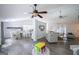 Open-concept living area with modern furnishings and hardwood floors connects to the kitchen and dining room at 95 Blue Grass Ct, Oxford, GA 30054