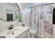 This bathroom features a stylish vanity, a round mirror, and a tub with a marble pattern shower curtain at 1017 Preserve Park Dr, Loganville, GA 30052