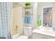 This bathroom features a tub with a shower and curtain, a toilet, vanity, and an organized shelf at 1017 Preserve Park Dr, Loganville, GA 30052