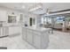Open kitchen with stainless steel appliances and island, flowing into the living area at 1017 Preserve Park Dr, Loganville, GA 30052