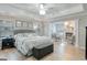 Spacious main bedroom with a tray ceiling, ceiling fan, fireplace, and neutral decor at 1017 Preserve Park Dr, Loganville, GA 30052