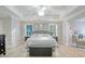 Spacious main bedroom with a tray ceiling, ceiling fan, three windows, and neutral decor at 1017 Preserve Park Dr, Loganville, GA 30052
