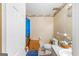 A simple bathroom includes a toilet, vanity, and shower with a blue curtain at 693 Trailwood Dr, Riverdale, GA 30274