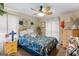 A fully furnished bedroom includes a queen bed, side tables, and ceiling fan at 693 Trailwood Dr, Riverdale, GA 30274