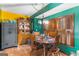 A cozy dining room features hardwood floors, a wooden table, and shuttered windows at 693 Trailwood Dr, Riverdale, GA 30274